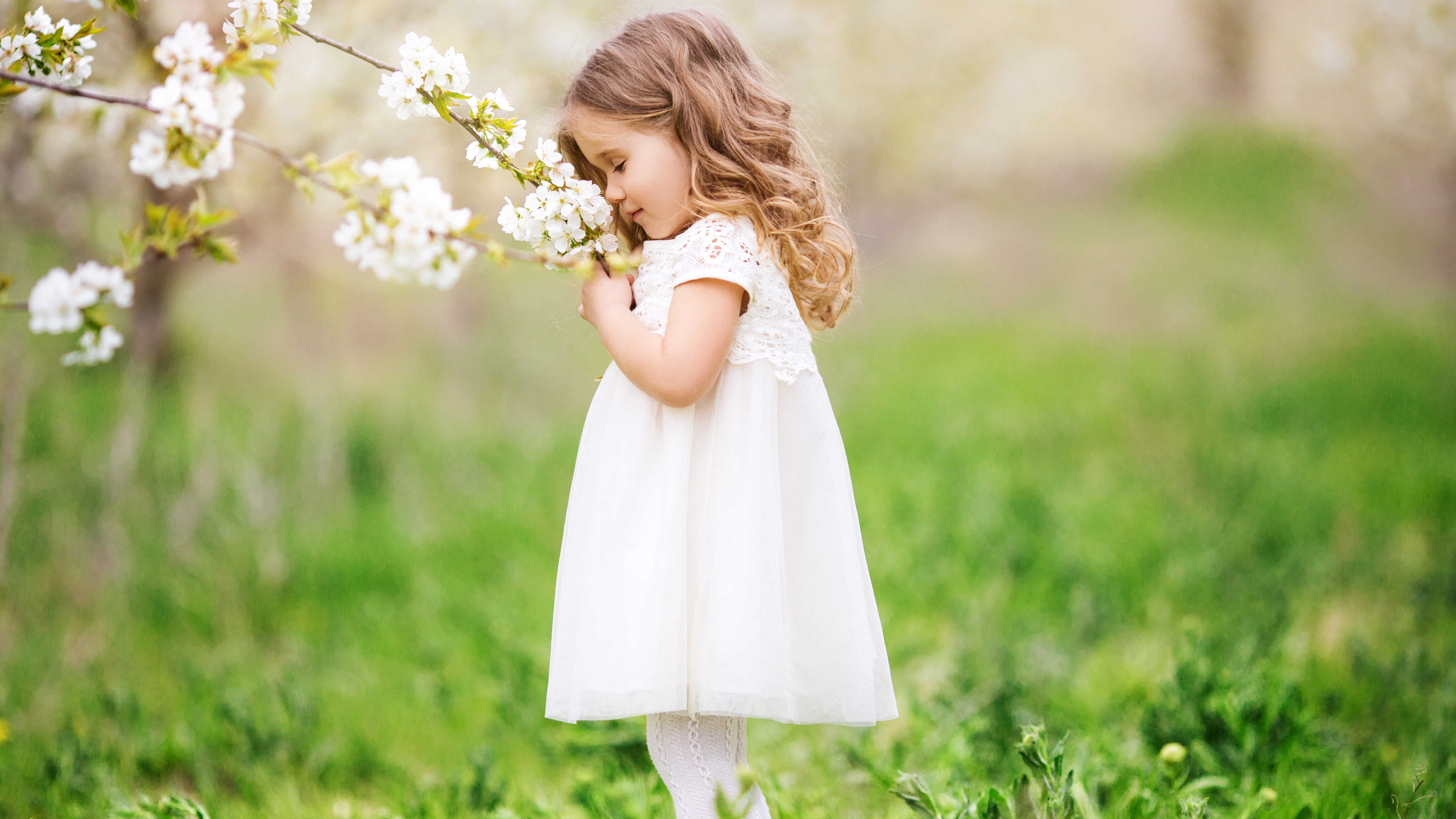 little-cute-girl-smelling-flowers-1k.jpg