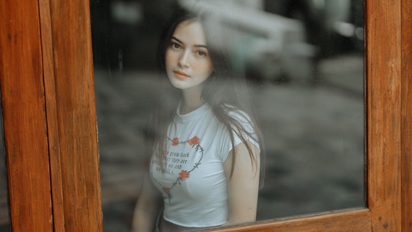 Beautiful Girl Looking Through Window Wallpaper
