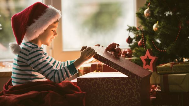 Boy Opening Christmas Present Wallpaper