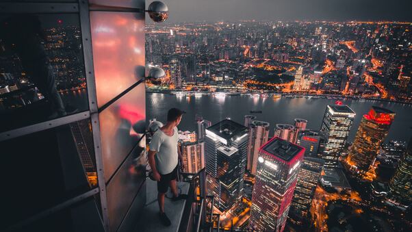 Boy Standing On The Rooftop Of Building Looking Down 5k Wallpaper