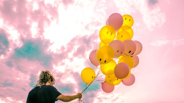Boy With Happy And Sad Balloons Wallpaper