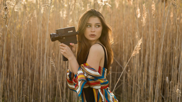 Brunette Girl In Field With Camera Wallpaper