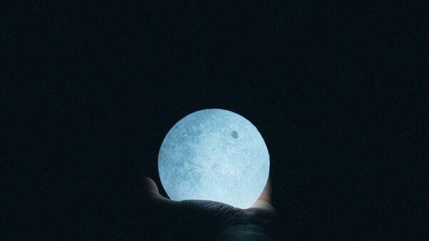 Close Up Photo Of Person Holding Moon Lamp Wallpaper