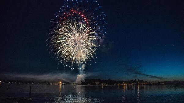 Fireworks Explosion Above Water Body 8k Wallpaper