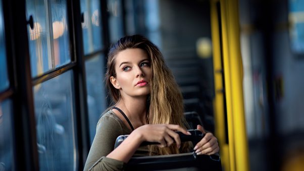 Girl In Bus Sitting Looking Back 4k Wallpaper