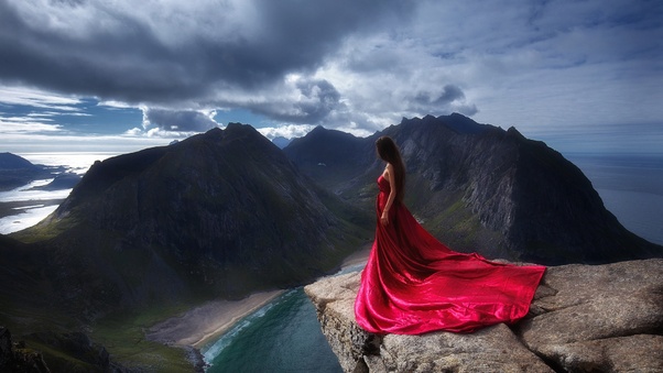 Girl In Red Dress Standing On The Edge Of Mountain Cliff Wallpaper