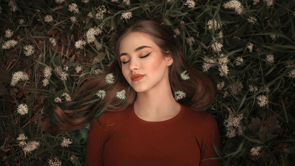 Girl Lying On Grass Bed Closed Eyes 4k Wallpaper