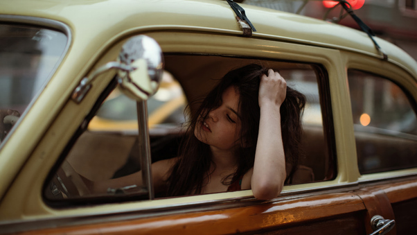 Girl Sitting In Car With Luggage On Top Wallpaper