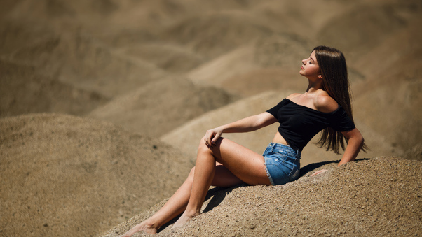 Girl Sitting Jean Shorts In Desert Wallpaper