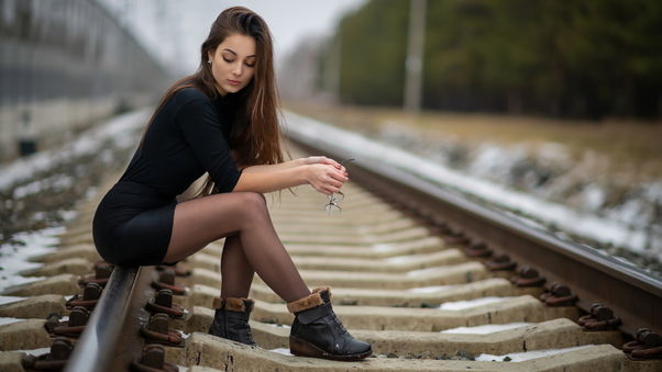 Girl Sitting On Railway Line 4k Wallpaper