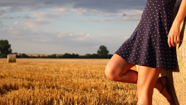 Girl Standing In A Field Wearing Polka Dot Dress Wallpaper