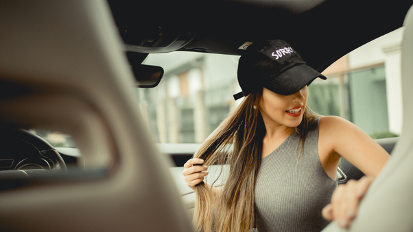 Girl With Basketball Cap In Car Wallpaper