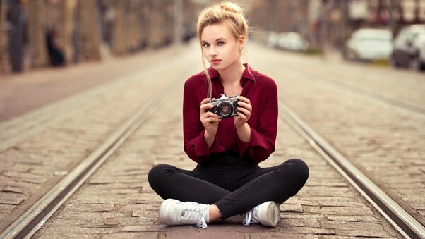 Girl With Camera Sitting On Tram Road Wallpaper
