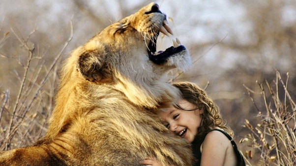 Little Girl Hugs Lion Roaring Cute 4k Wallpaper