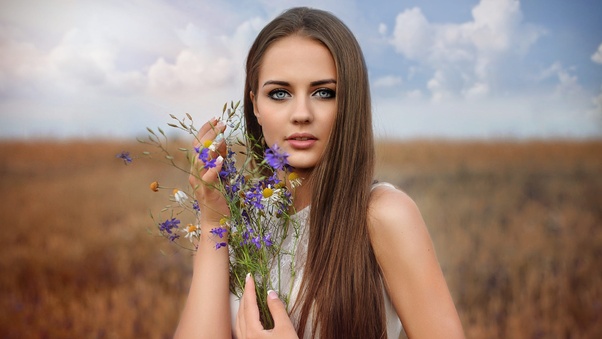 Long Hair Brunette With Flowers In Hand Field Wallpaper