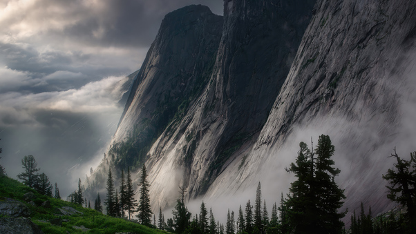 Majestic Peaks Embraced By Misty Clouds Wallpaper