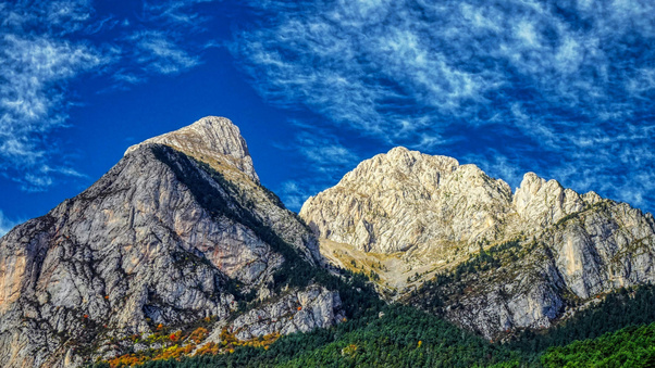 Majestic Stone Peaks Under Deep Blue Sky (2560x1440) Resolution Wallpaper