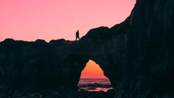 Man Walking Over Rock Silhouette Wallpaper