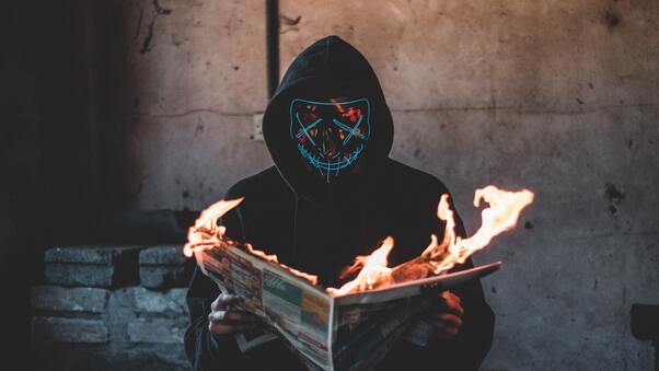 Mask Guy Reading A Burning News Paper Wallpaper
