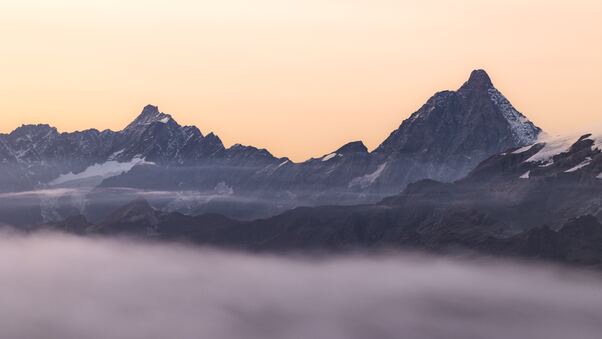 Mountain Range Covered In Fog Wallpaper