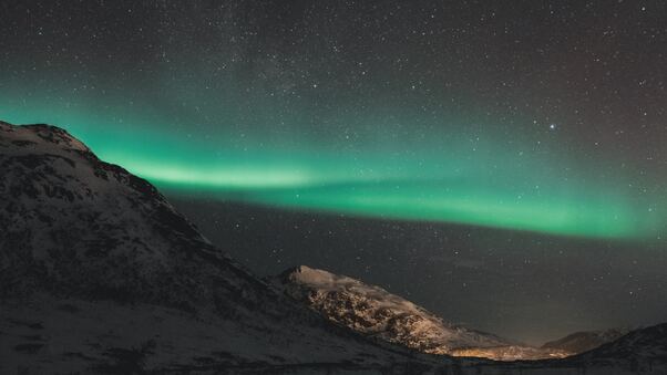 Northern Lights Over The Mountains Of Tromso Wallpaper