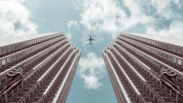 Plane Between Two Buildings 5k Wallpaper