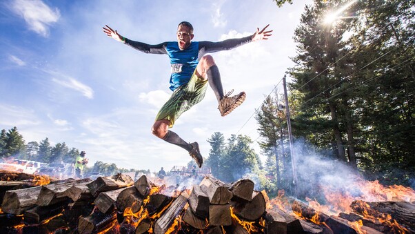 Player Jumping Out Of Burning Woods Wallpaper
