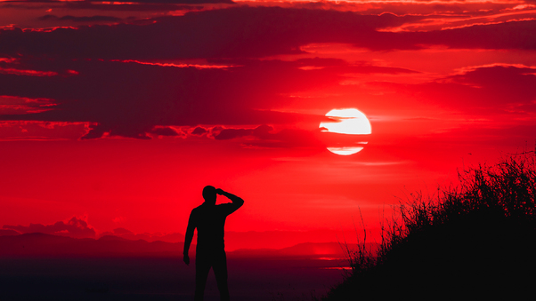 Silhouette Of Man During Red Sun Wallpaper