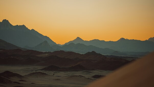 Sun Setting Over The Mountains In Desert Wallpaper