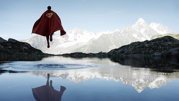 Superman Flying Above The Water Wallpaper