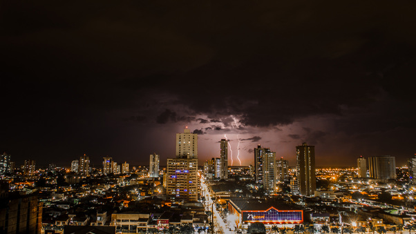 Thunderstorms Above City During Night Time Wallpaper