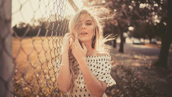 Woman Leaning On Chain Fence Wallpaper