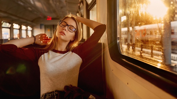 Women With Glasses Closed Eyes Sitting In Train Wallpaper