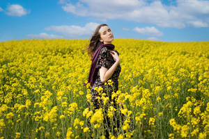 A Girl Amidst A Vibrant Field Of Sunflowers Wallpaper
