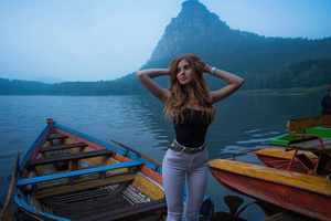 A Girl Posing On A Boat By The Lake Wallpaper
