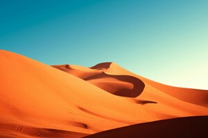 A Group Of Sand Dunes With A Blue Sky 8k (1600x900) Resolution Wallpaper