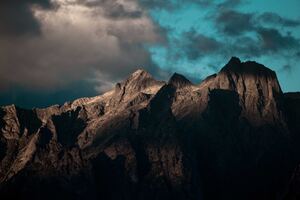 A Rocky Mountain With Clouds 5k Wallpaper