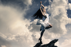 Brunette Girl Dancing On Mountain Top Clouds