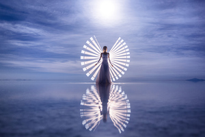 Brushstrokes Of Light Capturing A Girl In White Dress Presence Wallpaper