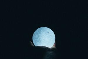 Close Up Photo Of Person Holding Moon Lamp