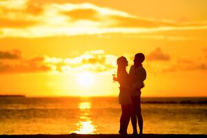 Couple At Beach During Sunset Wallpaper