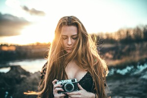 Girl Holding Camera (1366x768) Resolution Wallpaper