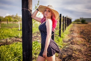 Girl In Hat And Dress Strikes A Pose By The Fence Wallpaper