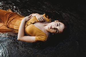 Girl Lying Down Orange Dress 4k (3840x2400) Resolution Wallpaper