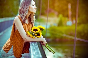 Girl Standing With Sun Flowers Wallpaper