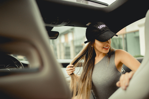 Girl With Basketball Cap In Car (2560x1440) Resolution Wallpaper