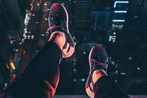 Hanging Shoes In Air City Night View 4k (1336x768) Resolution Wallpaper