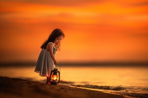 Little Girl On Beach Near Shutdown With Her Lantern