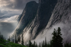 Majestic Peaks Embraced By Misty Clouds Wallpaper