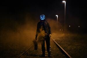 Mask Guy Walking On Railroad